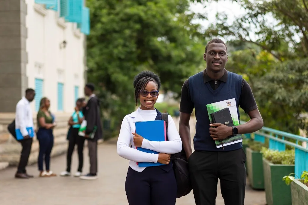 Makerere University students on campus with study materials
